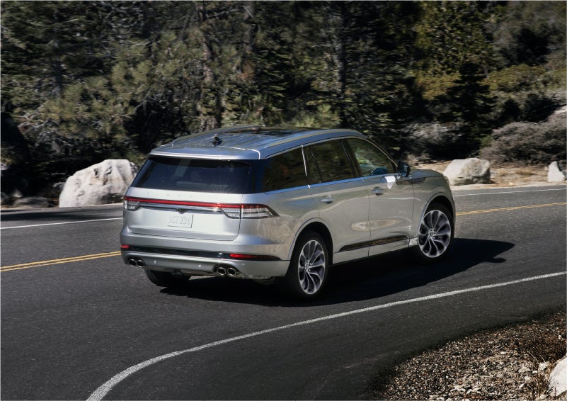 A 2023 Lincoln Aviator® Grand Touring model is shown being driven on a tight turn of a mountain road | Irwin Lincoln Laconia in Laconia NH